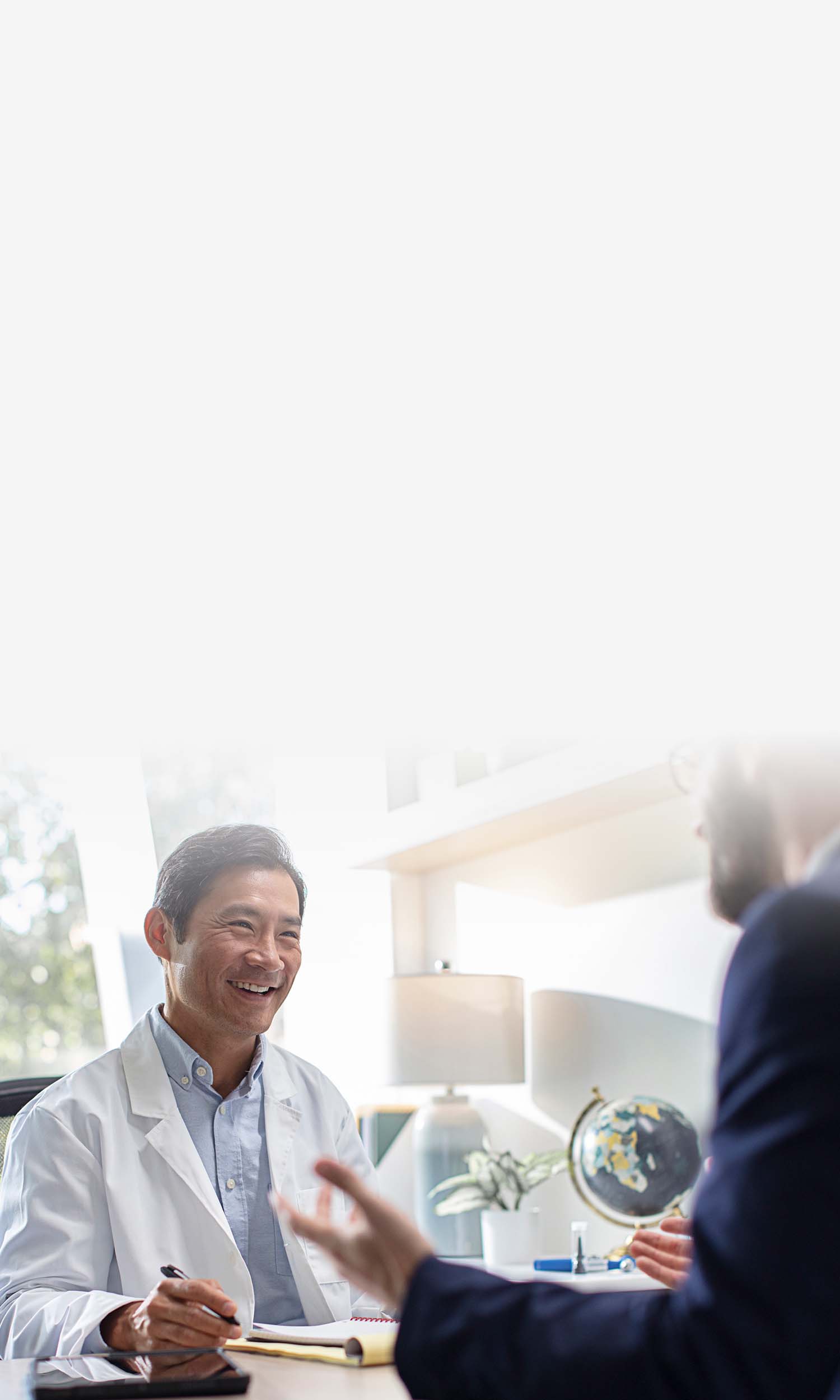 A smiling hearing professional talking to a consultant