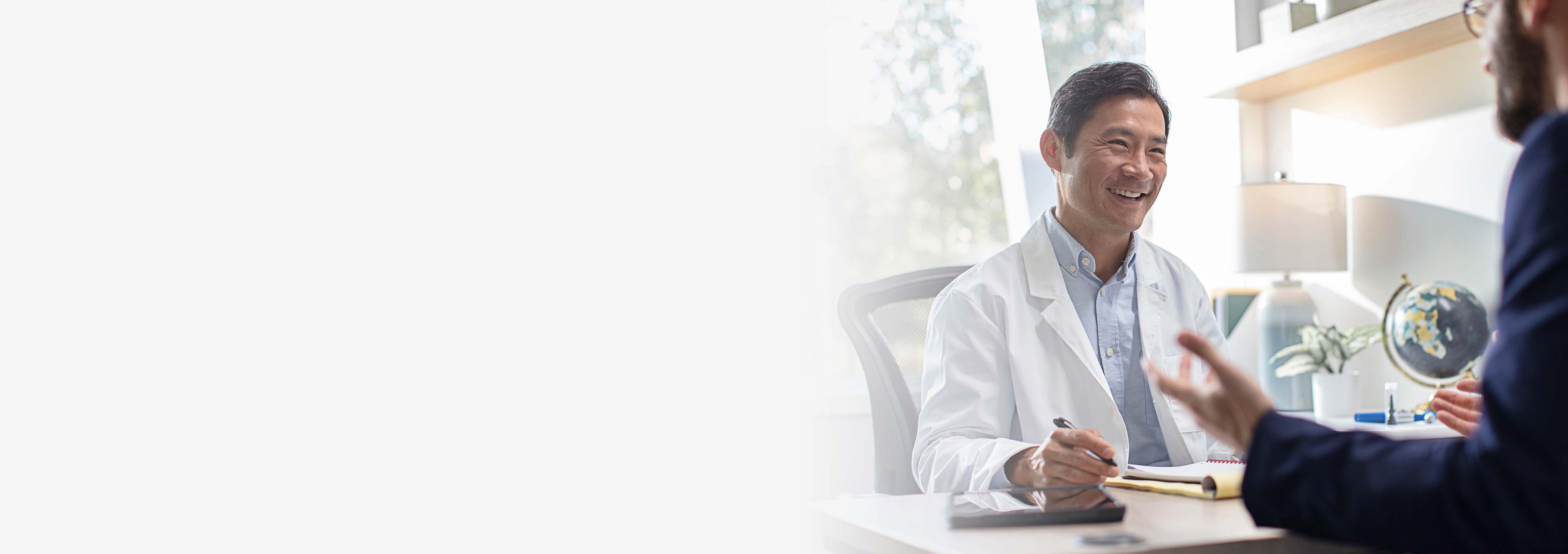 A smiling hearing professional talking to a consultant