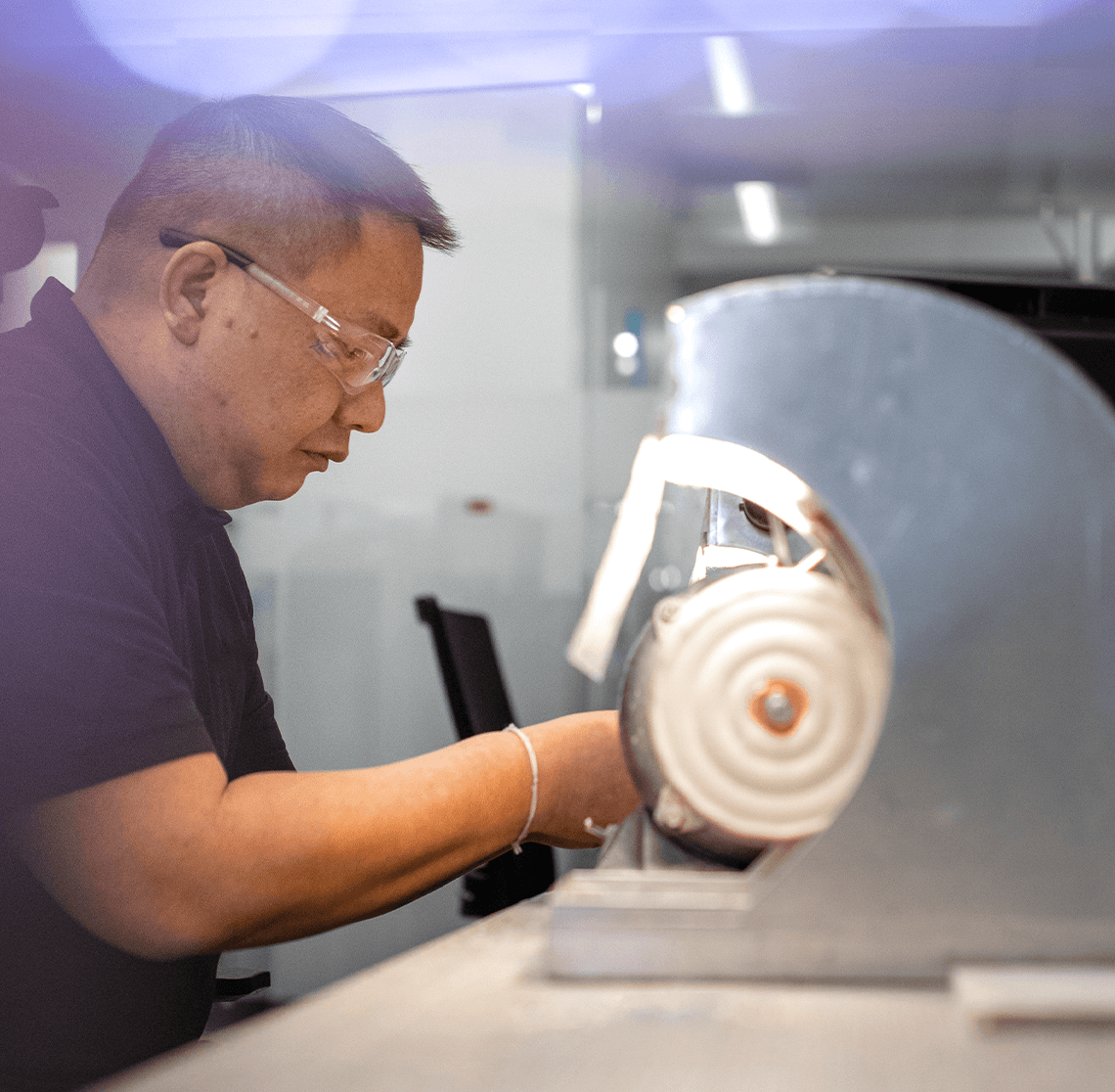 Technician working on buffing wheel
