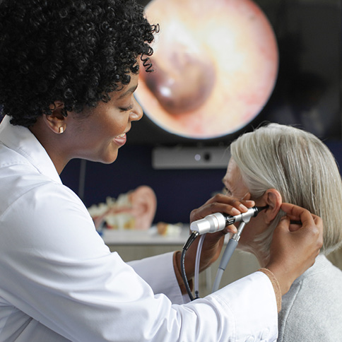 Woman checking women's ear