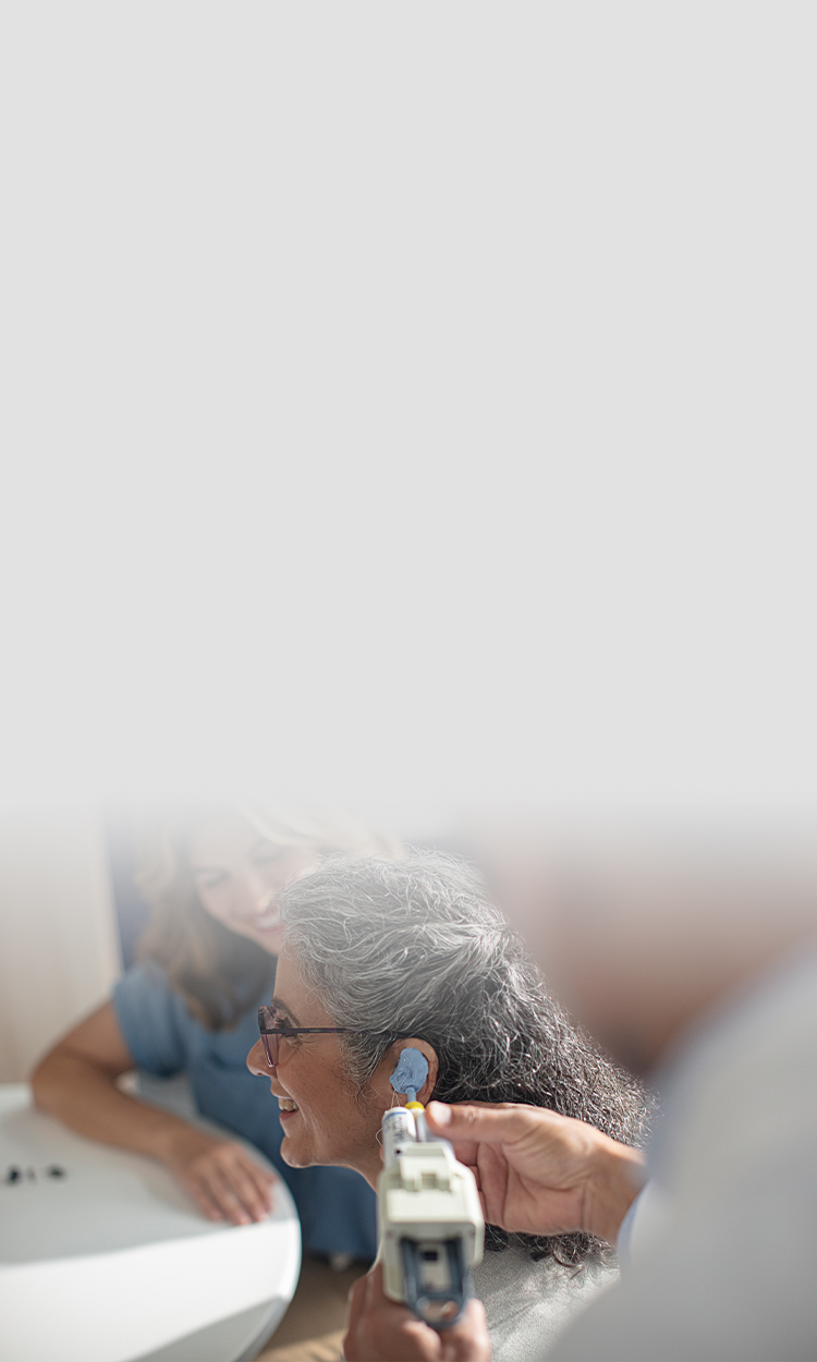 A woman getting her ear impression taken