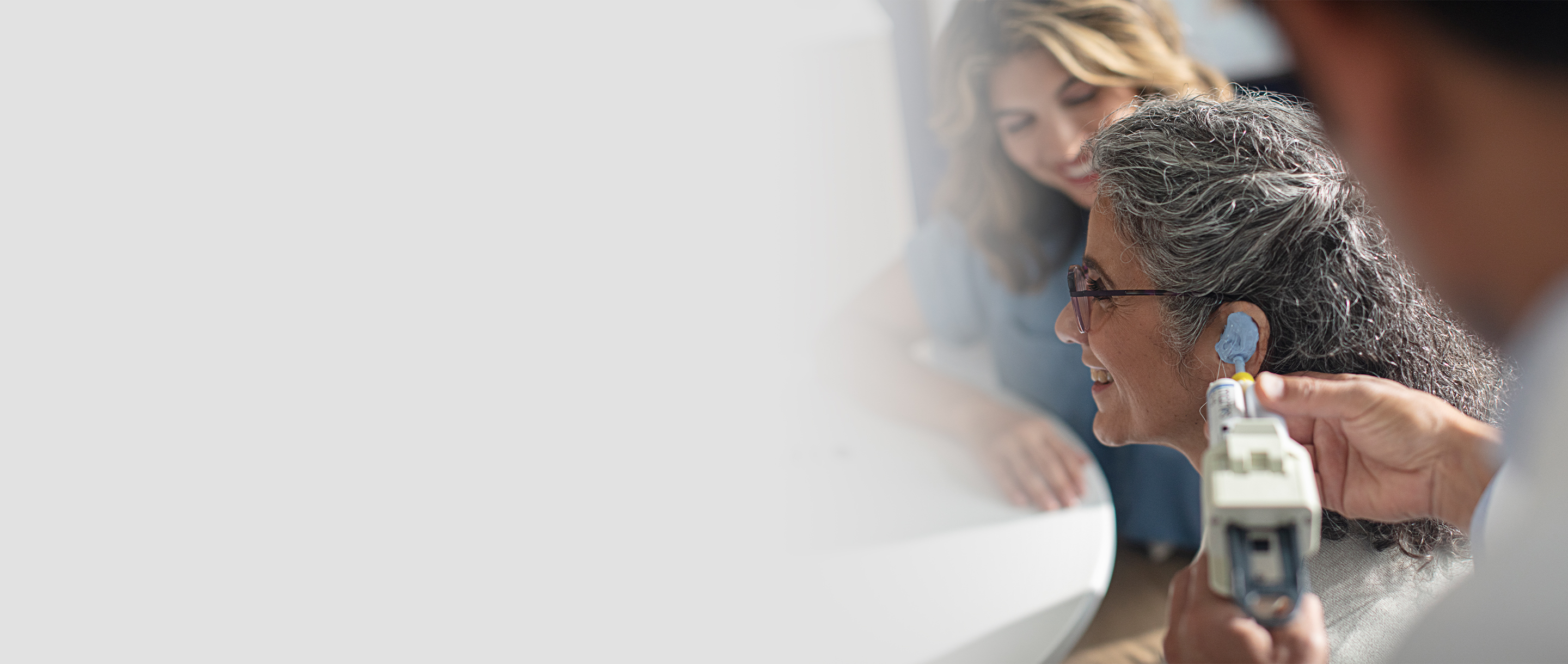 A woman getting her ear impression taken