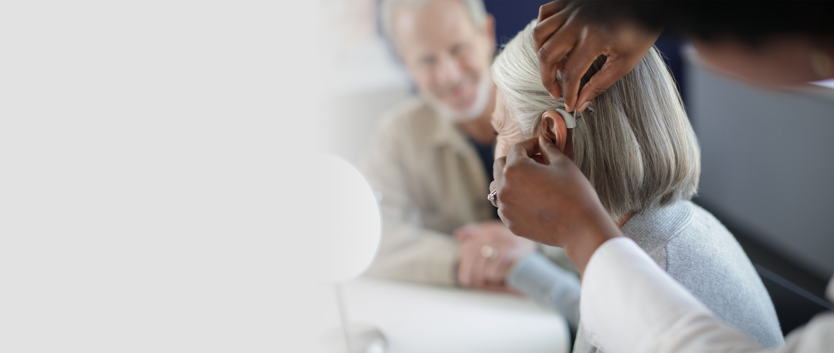 A woman being fit with a hearing aid
