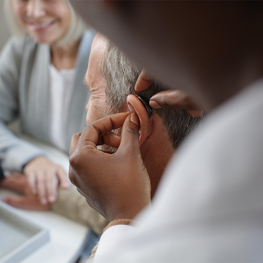 Man being fit with a RIC hearing aid