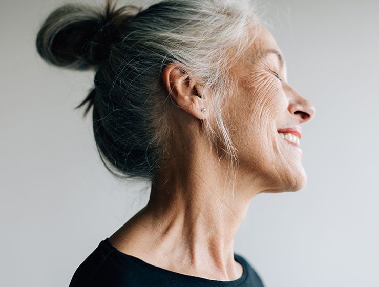 Profile of woman smiling.